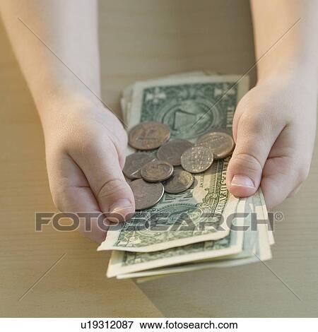 Boy holding money View Large Photo Image Stock Photo - Boy holding money. Fotosearch