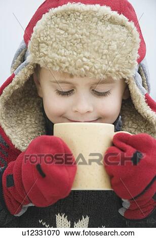 Boy in warm hat drinking hot chocolate View Large Photo Image Stock Image - Boy in warm hat drinking hot chocolate. Fotosearch