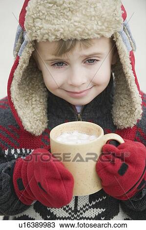Boy in warm hat drinking hot chocolate View Large Photo Image Stock Image - Boy in warm hat drinking hot chocolate. Fotosearch