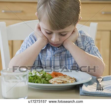 Boy looking at dinner View Large Photo Image Stock Photo - Boy looking at dinner. Fotosearch
