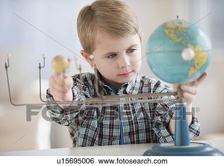 Stock Photograph - Boy looking at globe. Fotosearch