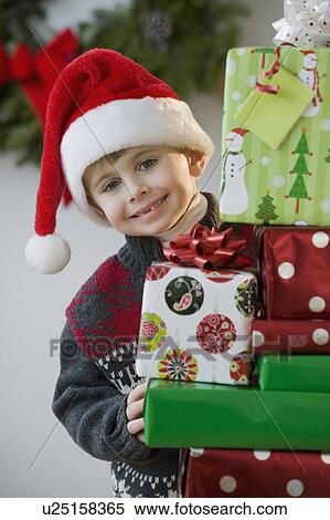 Stock Photography - Boy posing with Christmas gifts. Fotosearch