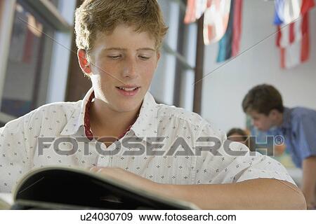 Boy reading in library View Large Photo Image Stock Photo - Boy reading in library. Fotosearch