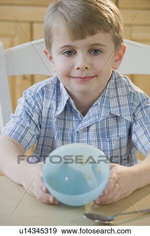 Boy showing empty bowl View Large Photo Image Stock Photo - Boy showing empty bowl. Fotosearch