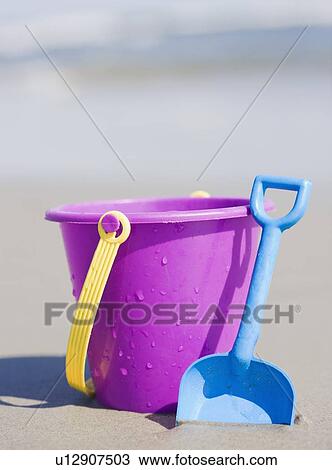 Bucket and shovel on beach View Large Photo Image Stock Image - Bucket and shovel on beach. Fotosearch
