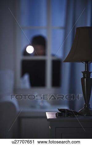 Burglar looking in house window View Large Photo Image Stock Image - Burglar looking in house window. Fotosearch