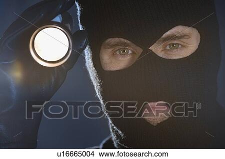 Burglar shining flashlight View Large Photo Image Picture - Burglar shining flashlight. Fotosearch