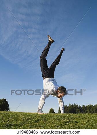 Businessman doing handstand outdoors View Large Photo Image Stock Photography - Businessman doing handstand outdoors. Fotosearch