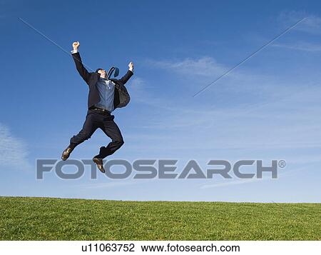 Businessman jumping in air View Large Photo Image Stock Image - Businessman jumping in air. Fotosearch