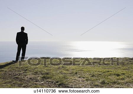 Businessman looking toward ocean View Large Photo Image Stock Photograph - Businessman looking toward ocean. Fotosearch