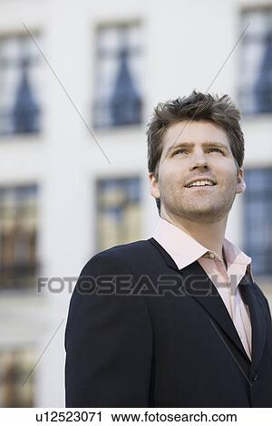 Stock Image - Businessman looking up. Fotosearch