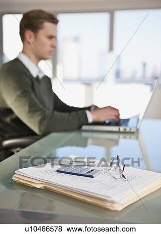 Stock Photo - Businessman working in office. Fotosearch