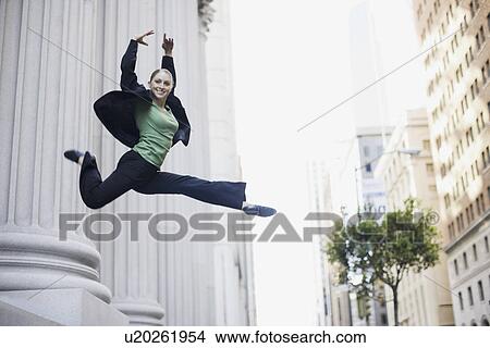 Businesswoman dancing in urban setting View Large Photo Image Picture - Businesswoman dancing in urban setting. Fotosearch