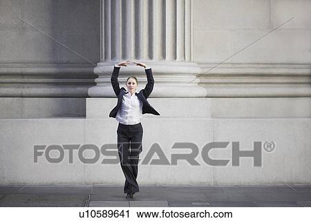 Businesswoman dancing in urban setting View Large Photo Image Stock Image - Businesswoman dancing in urban setting. Fotosearch