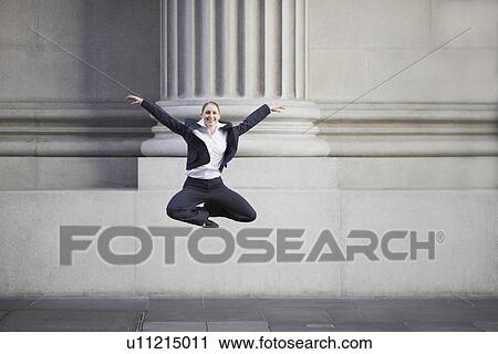 Businesswoman dancing in urban setting View Large Photo Image Stock Image - Businesswoman dancing in urban setting. Fotosearch
