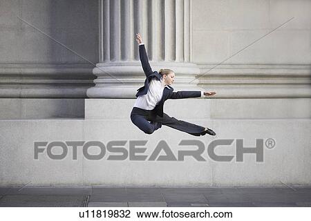 Businesswoman dancing in urban setting View Large Photo Image Stock Image - Businesswoman dancing in urban setting. Fotosearch