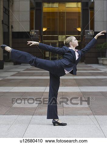 Businesswoman dancing in urban setting View Large Photo Image Stock Image - Businesswoman dancing in urban setting. Fotosearch