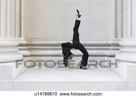 Businesswoman dancing in urban setting View Large Photo Image Stock Image - Businesswoman dancing in urban setting. Fotosearch