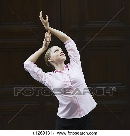 Businesswoman dancing in urban setting View Large Photo Image Stock Photo - Businesswoman dancing in urban setting. Fotosearch