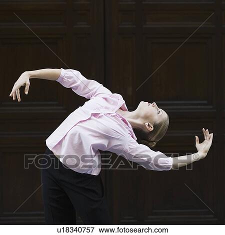 Businesswoman dancing in urban setting View Large Photo Image Stock Photo - Businesswoman dancing in urban setting. Fotosearch