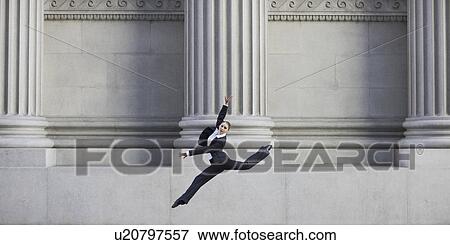 Businesswoman dancing in urban setting View Large Photo Image Stock Photo - Businesswoman dancing in urban setting. Fotosearch