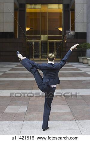 Stock Photograph - Businesswoman dancing in urban setting. Fotosearch