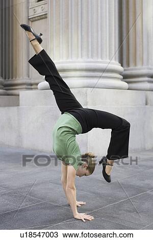 Businesswoman dancing on urban sidewalk View Large Photo Image Stock Image - Businesswoman dancing on urban sidewalk. Fotosearch
