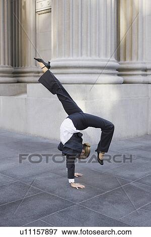 Businesswoman dancing on urban sidewalk View Large Photo Image Stock Photo - Businesswoman dancing on urban sidewalk. Fotosearch