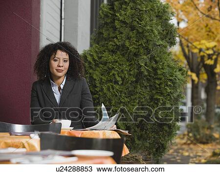 Businesswoman sitting at outdoor cafe View Large Photo Image Stock Image - Businesswoman sitting at outdoor cafe. Fotosearch