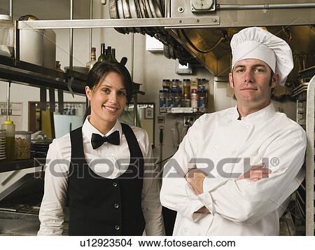 Chef and waitress posing in restaurant kitchen View Large Photo Image Picture - Chef and waitress posing in restaurant kitchen. Fotosearch
