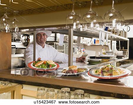 Chef in restaurant kitchen View Large Photo Image Stock Photo - Chef in restaurant kitchen. Fotosearch