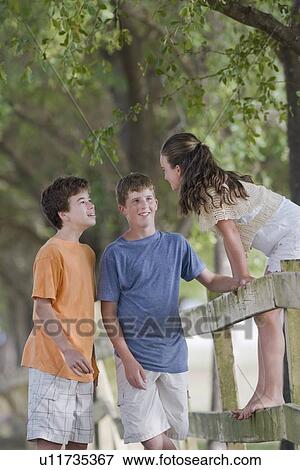 Stock Photo - Children playing in fence. Fotosearch