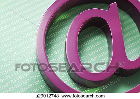 Stock Photo - Close up of “at’ symbol and binary code. Fotosearch