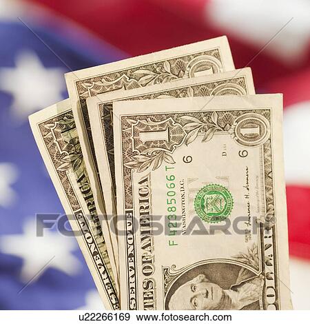 Stock Photo - Close up of coin in piggy bank slot. Fotosearch