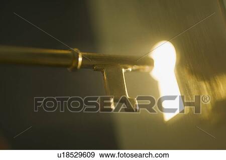 Close up of keyhole and key View Large Photo Image Stock Photo - Close up of keyhole and key. Fotosearch