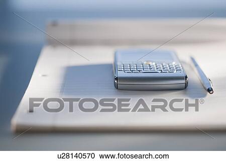 Close up of notepad and electronic organizer View Large Photo Image Stock Image - Close up of notepad and electronic organizer. Fotosearch