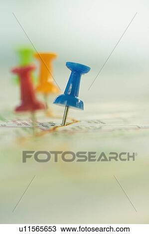 Stock Image - Close up of pins on map locations. Fotosearch