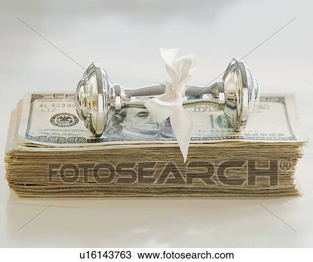 Stock Image - Close up of silver baby rattle. Fotosearch