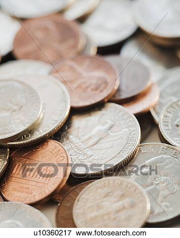 Stock Photo - Coins and paper dollar bills. Fotosearch