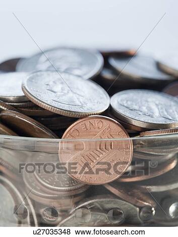 Coins in savings jar View Large Photo Image Stock Photo - Coins in savings jar. Fotosearch