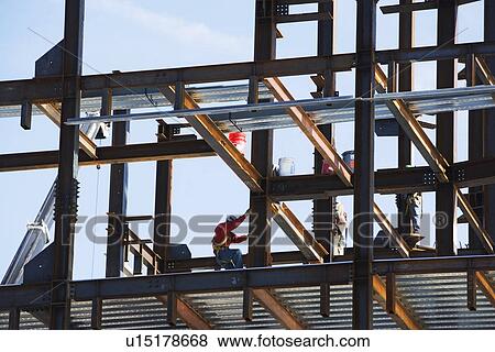 Construction worker on beams View Large Photo Image Stock Photo - Construction worker on beams. Fotosearch