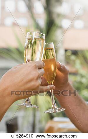 Couple toasting with champagne View Large Photo Image Stock Image - Couple toasting with champagne. Fotosearch