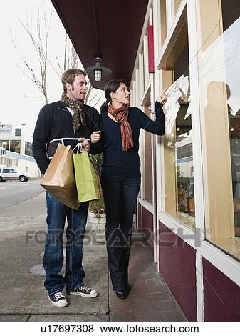 Couple window shopping View Large Photo Image Stock Photo - Couple window shopping. Fotosearch