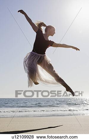 Stock Photo - Dancer leaping on beach. Fotosearch