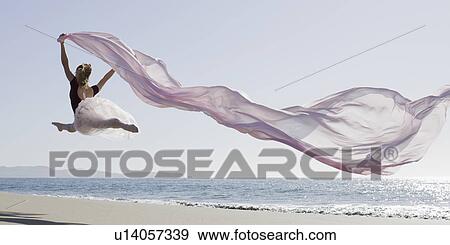 Stock Photo - Dancer leaping on beach. Fotosearch