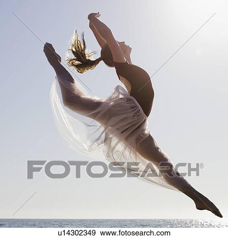 Stock Photo - Dancer leaping on beach. Fotosearch