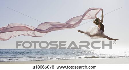 Stock Photo - Dancer leaping on beach. Fotosearch