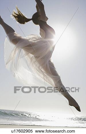 Stock Photography - Dancer leaping on beach. Fotosearch