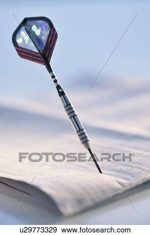 Stock Photo - Dart on stock pages. Fotosearch