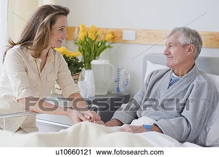 Daughter visiting senior father in hospital View Large Photo Image Stock Image - Daughter visiting senior father in hospital. Fotosearch